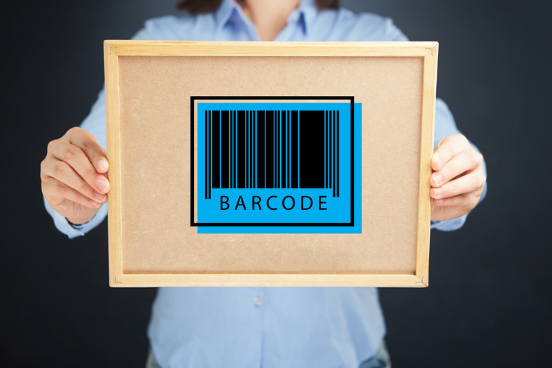 Hands holding a board with a barcode